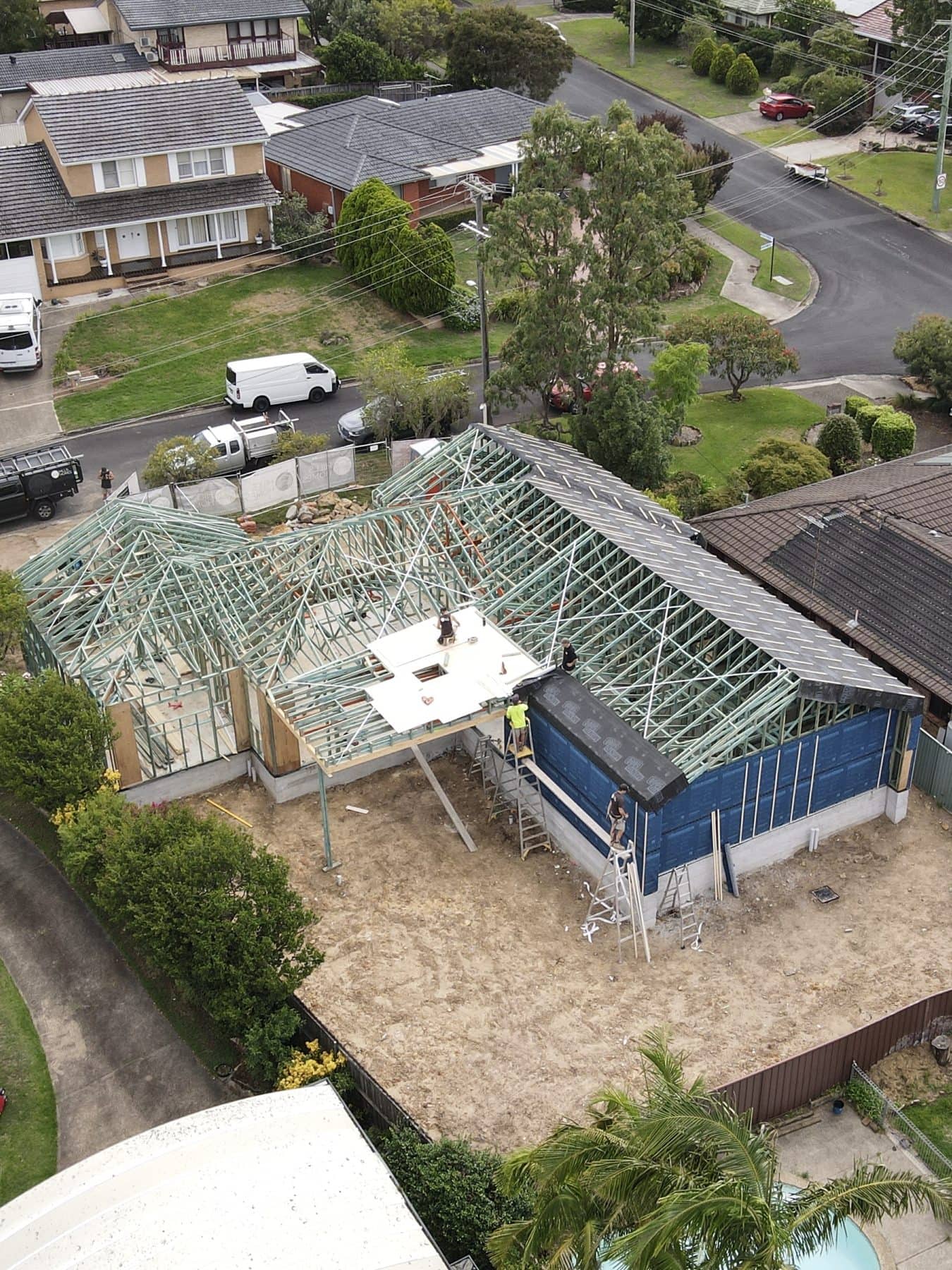 Aerial view of a Hills Homes knockdown rebuild with frame and roof trusses up