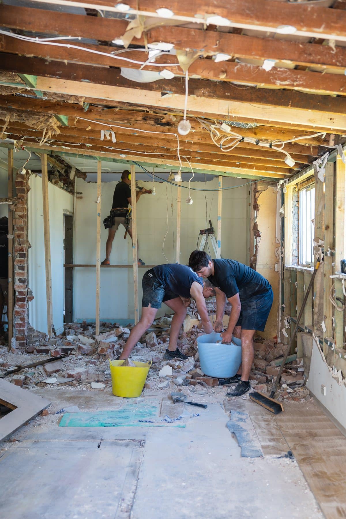 Hills Homes crew stripping out a room during a renovation